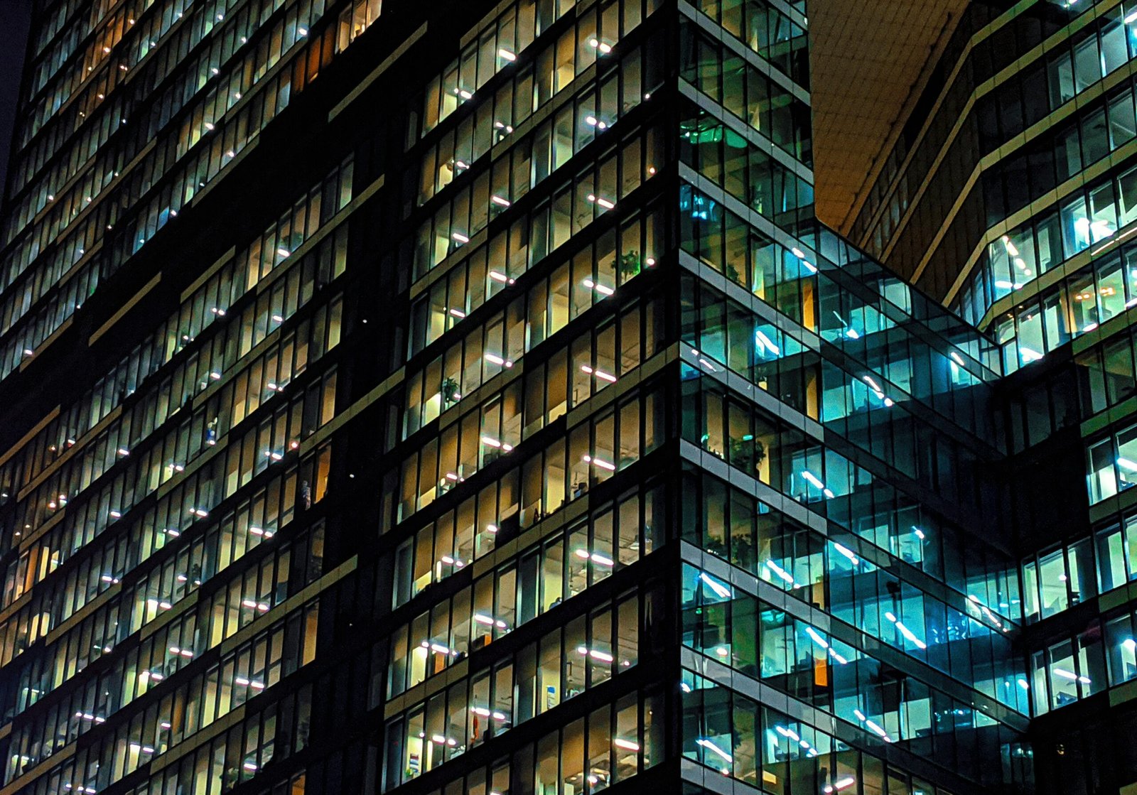 a very tall building with lots of windows at night